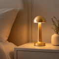 MahMir Dome Cordless Rechargeable LED Table Lamp in gold on a bedroom nightstand