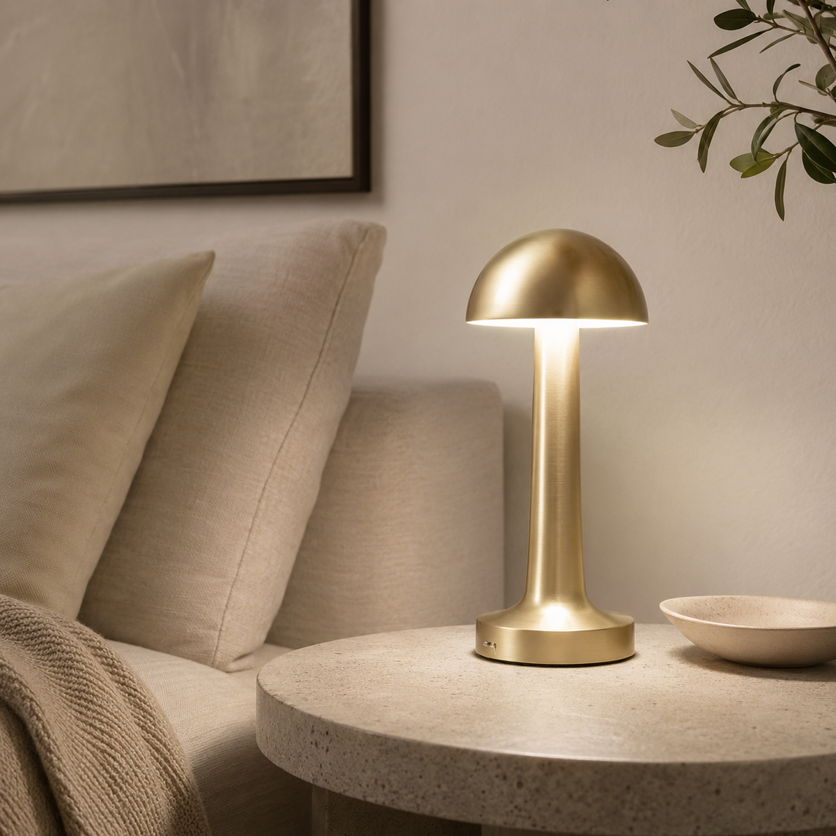 MahMir Dome Cordless LED Table Lamp in gold on a round side table by a sofa