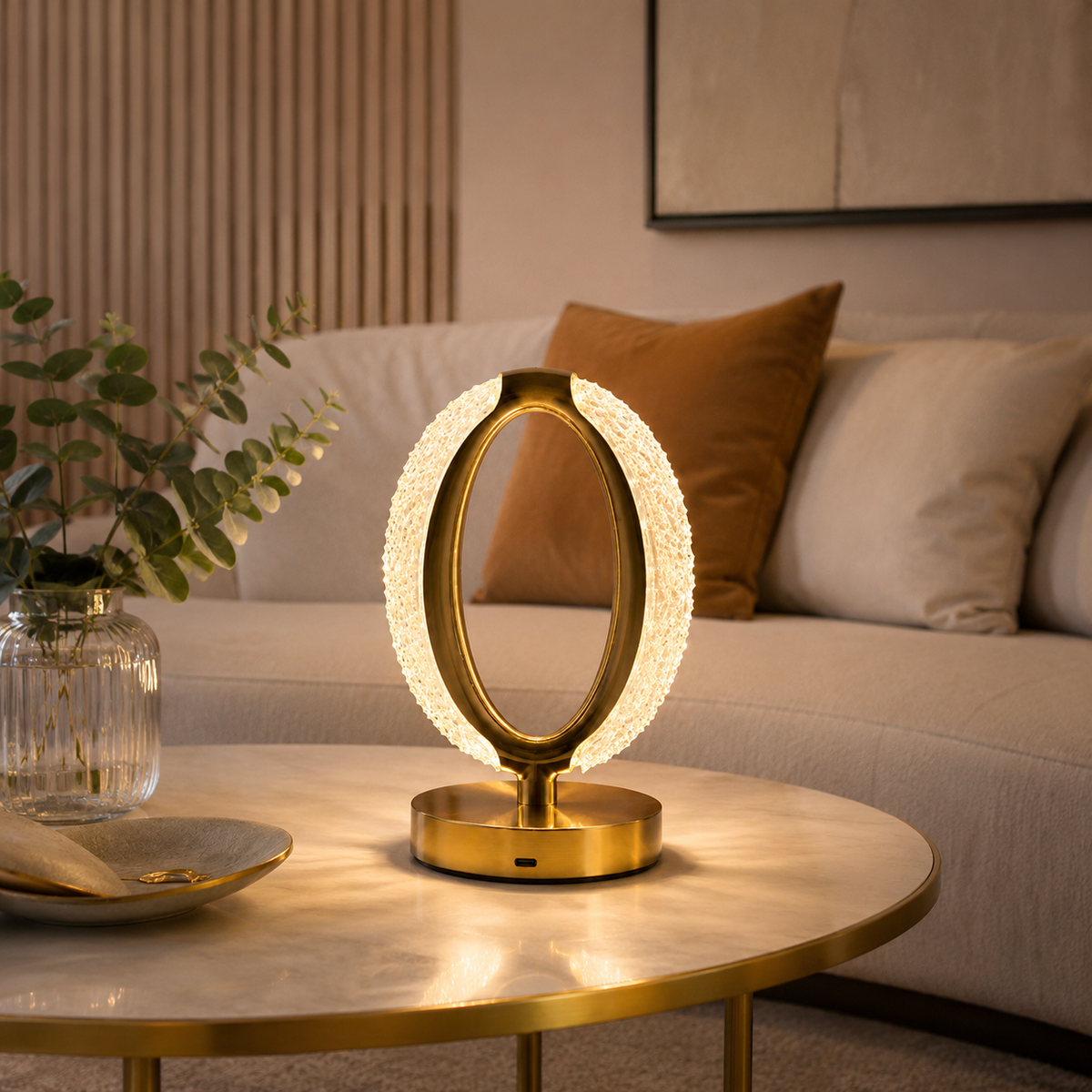 Gold oval crystal halo table lamp on a round marble coffee table in a living room