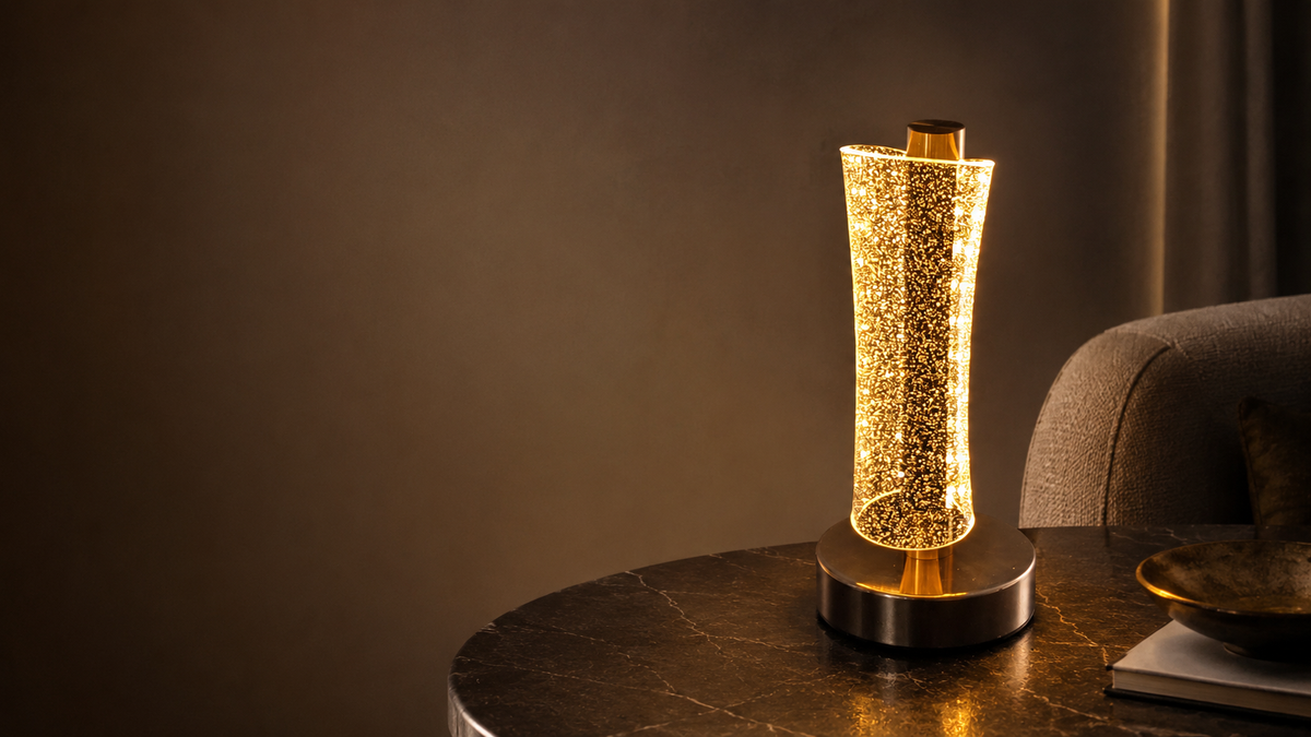 Tall crystal column LED table lamp on a dark marble side table