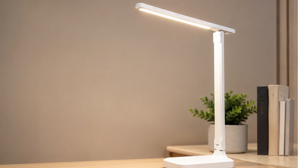 White MahMir LED desk lamp with slim adjustable arm on a wooden desk